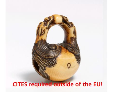 NETSUKE: MOKUGYÔ WITH DRAGON HEADS AS HANDLE.  Japan. 19th c.  Ivory with dark stained engraving, amber yellow patina. H.4.4c