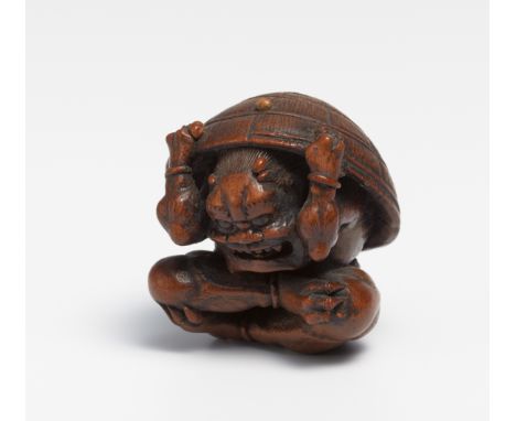 NETSUKE OF A SETSUBIN ONI AT NEW YEAR.  Japan. 19th c.  Box wood, carved and polished, beans partly inlaid. Since the lucky b