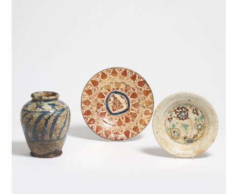 TWO DISHES AND A VASE.  Persia. Safawid dynasty (1501-1722).  Stonepaste painted, glaze partly with crazing. Dish Ø 23.2/19.5