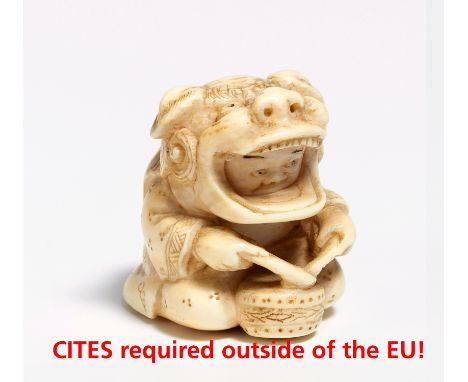 NETSUKE: DRUMMING BOY WITH LION MASK.  Japan. 19th c.  Ivory carved. Underneath denoted: Tomoyuki. H.3cm. Condition A.  Prove