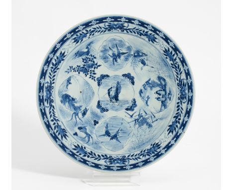 LARGE DISH WITH HOTEI, LANDSCAPE MEDALLIONS, BIRDS AND WATER ANIMALS.  Japan. 19th c.  Porcelain painted underglaze blue. H.5