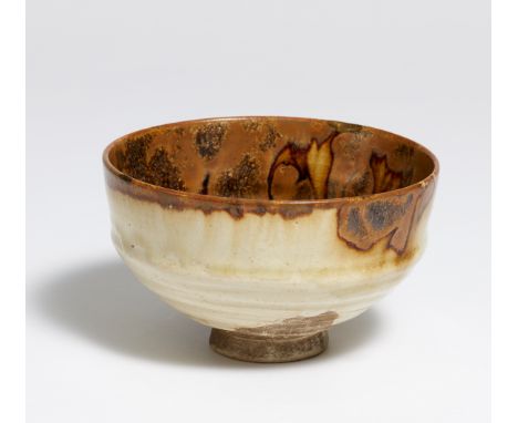 TEABOWL (CHAWAN) WITH IRON GLAZE.  Japan. 18th-19th c.  Thinly turned, light colored and fine stoneware. On the outside glaze