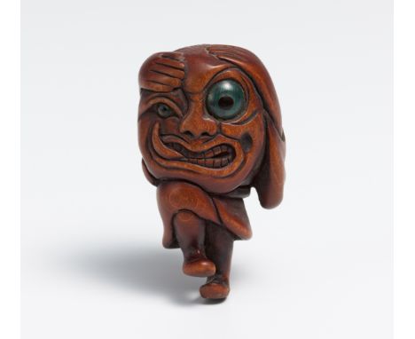 NETSUKE OF A GHOST WITH A LARGE HEAD (ÔKUBI BAKEMONO).  Japan. 19th c.  Dark wood, carved, eyes inlaid in malachite. H.4.5cm.