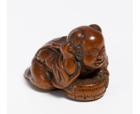 NETSUKE: DUMMING KARAKO.  Japan. Early 19th c.  Wood, carved. L.3.7cm. Condition A/B.Special Conditions Art &amp; Interior AR
