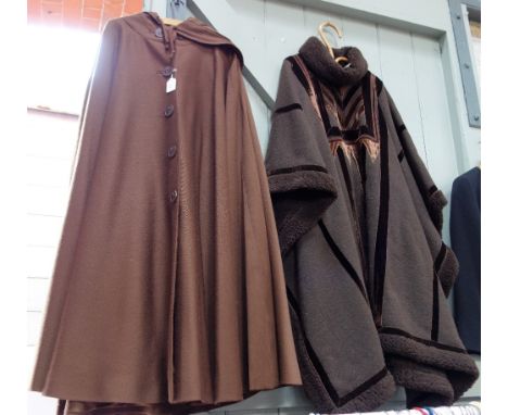 A FULL LENGTH CHOCOLATE BROWN WOOLLEN CAPE with hood, fully lined with five button-through fastening and another by Boza Kosa