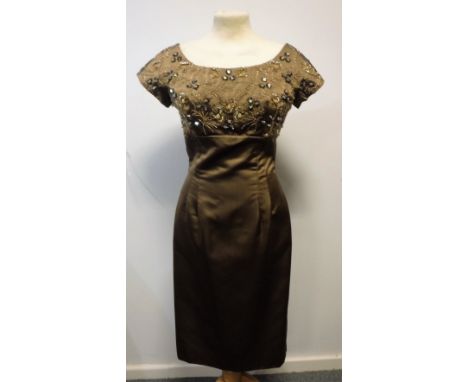 1960'S CHOCOLATE COLOURED SATIN 'WIGGLE' DRESS, size 10, cap sleeve and empire line, the bodice decorated with gold, clear an