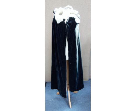 A VINTAGE BLACK VELVET OPERA CAPE with a green velvet lining