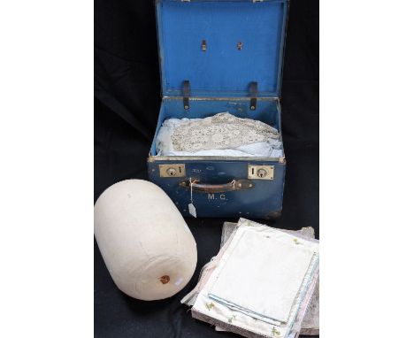 A VINTAGE NAVY BLUE BOX TRUNK containing a quantity of lace, including a lace making pillow and other lace making items as lo