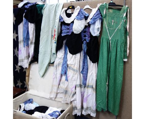 A LARGE VINTAGE WOVEN LAUNDRY HAMPER with a canvas cover, containing Vintage clothes