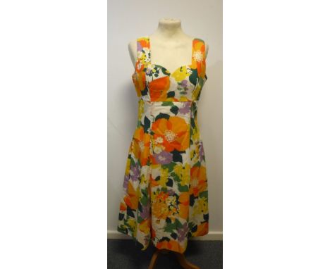 A VINTAGE 1960'S SLEEVELESS TENNIS DRESS, fashioned in raw cotton, with button detail to bodice and another brightly coloured