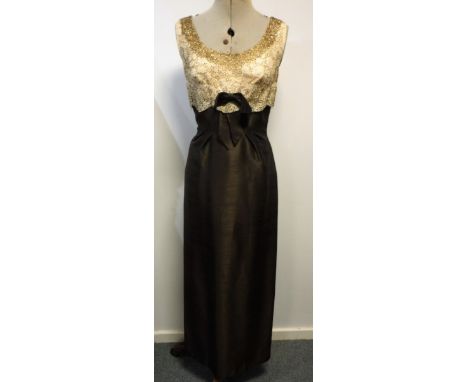 REBUCK FOR MAYFAIR, CHOCOLATE BROWN SATIN AND GOLD EVENING DRESS, bodice decorated with champagne coloured lace, encrusted wi