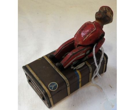A VINTAGE GERMAN TINPLATE CLOCKWORK "LUGGAGE PORTER" with a large cabin trunk