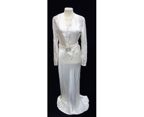 A 1940's SATIN WEDDING DRESS, with button through front, belt detail and the sleeves and shoulders decorated with beads