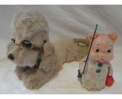 A VINTAGE CLOCKWORK POODLE, with a plush coat and musical action and a Vintage clockwork pig in a nightdress (2)