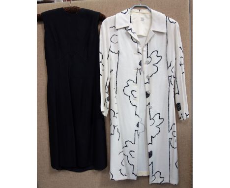 CARNEGIE OF LONDON; A VINTAGE LADIES BLACK LINEN DRESS and a similar long white linen coat with stylised black detail, circa 