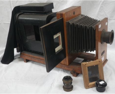 AN EDWARDIAN MAGIC LANTERN, "THE NATIONAL" with an oak front with adjustable bellows and tin body