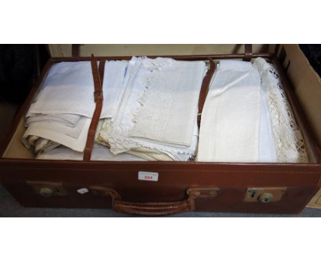 LARGE BROWN LEATHER VINTAGE SUITCASE, containing a quantity of vintage linen tablecloths and other similar items