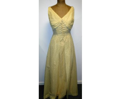 A YELLOW FULL LENGTH VOILE 1950'S EVENING DRESS, the body adorned with small daisy flowers, button through detail to the fron