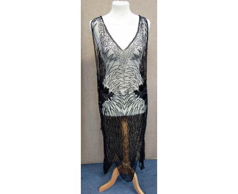 A VINTAGE BLACK 1920'S SHEER EVENING DRESS with allover black bugle bead decoration NB: in fragile condition