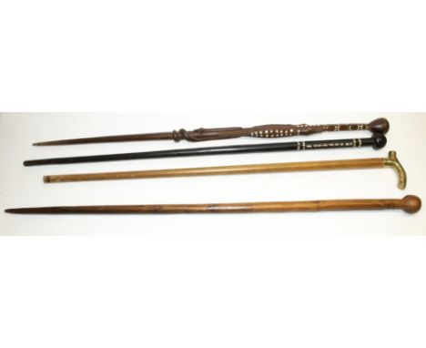 Two Solomon Islands carved wood canes with inlaid pearl decoration, both L93cm, and two other canes / walking sticks (4) 