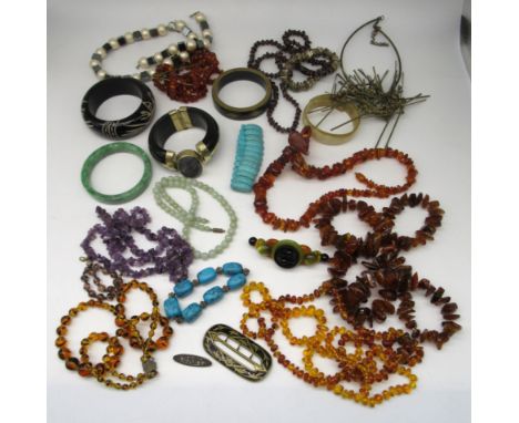 Semi precious jewellery including a carved jade bangle, an amethyst necklace, amber beads and a collection of vintage and mod