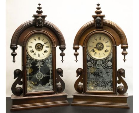 Two early C20th Ansonia Clock Company mahogany cased shelf clock alarms, carved cases with drop down finials, cream Roman dia