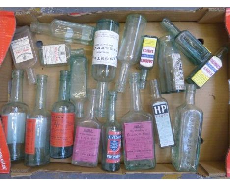 A crate of glass bottles including wine. 