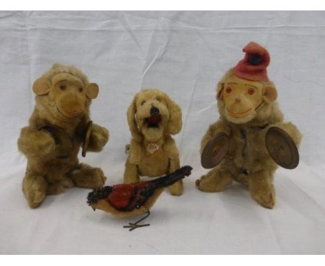Two clockwork seated monkey, both playing the cymbals, also a clockwork dog by Victory and a small clockwork and tinplate bir