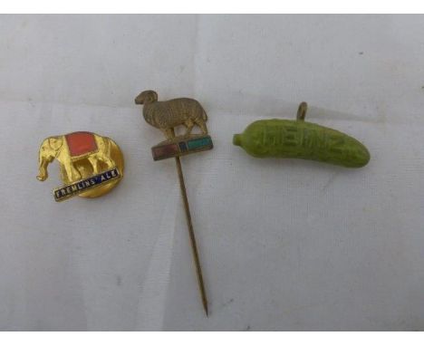 A Fremlin's Ale part enamel elephant badge by H.W. Miller, a Heinz gherkin pendant and a stick pin in the form of a standing 