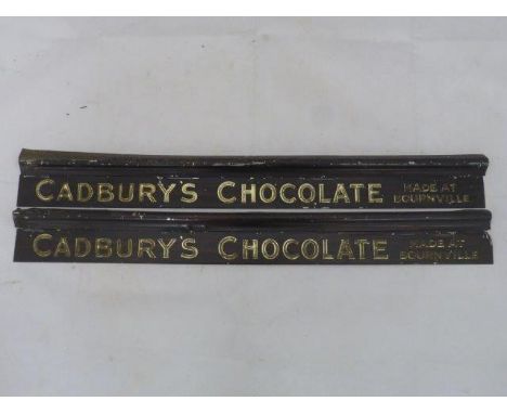 A pair of Cadbury's Chocolate embossed shelf strips.