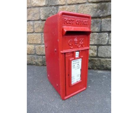 An early post box bearing the letters G.R., with white enamel inserts detailing collections from Worminghall.