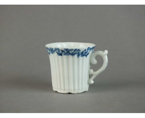 An early Worcester fluted coffee cup circa 1753-54 with vertical reeding, scroll handle, painted with a blue scrolling flower