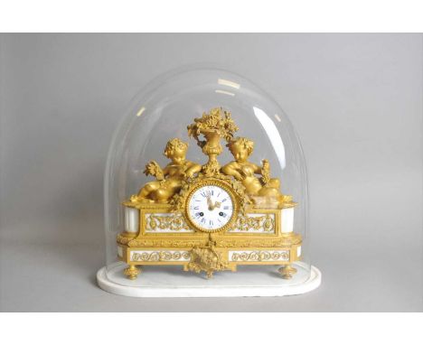 A 19th century French ormolu and white marble mantle clock, the white enamel dial with black Arabic and blue Roman numerals, 