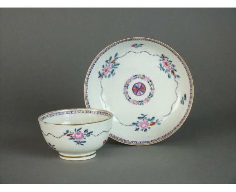 A Caughley teabowl and saucer circa 1792-99 painted in polychrome with a version of the 'Target' pattern, with a central moti