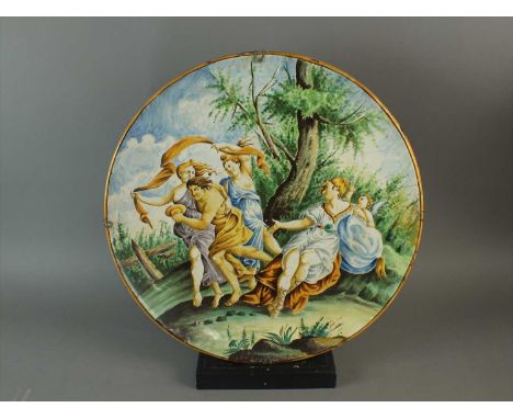 A large Italian maiolica charger, late 19th century painted in the Castelli manner with a mythological scene of figures a tre