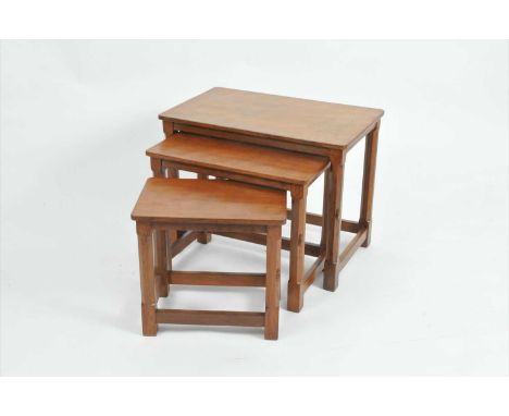 A Robert 'Mouseman' Thompson nest of three graduating occasional tables, each with adzed tablet tops over chamfered octagonal