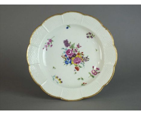 A Worcester plate, circa 1770 of circular form with ozier-moulded border, centrally painted in polychrome with central sprays