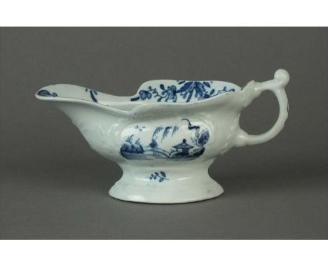 An uncommon Worcester 'Sinking Boat Fisherman' sauce boat circa 1756 painted in blue, of silver-shape with rococo moulding, r