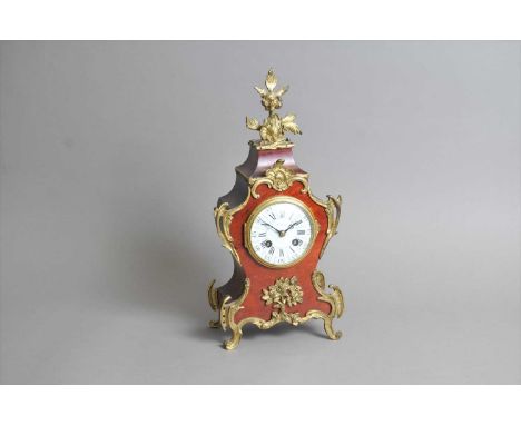 A small simulated boulle mantle clock, with a divided enamel dial with Roman and Arabic numerals, indistinctly signed, the mo