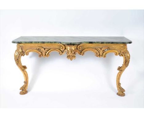 A 20th century baroque style hall or console table, gilded throughout with carved mounts and scrolling borders, raised on swe