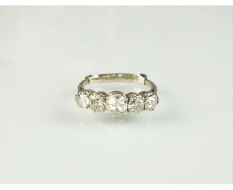 A five stone diamond ring, the graduated old cut diamonds claw set in white metal to white metal shank, ring size K 1/2, weig