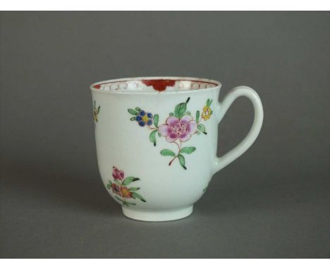 A Worcester coffee cup circa 1762 of plain U shape with an indented loop handle, painted in famille rose colours with regular