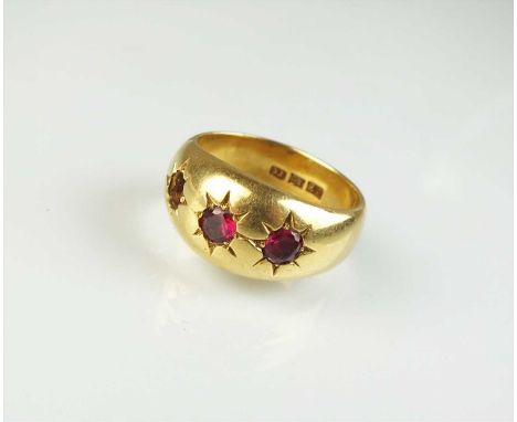 An untested ruby ring, the two round mixed cut rubies within star setting, the shank stamped '18', ring size X, weight approx