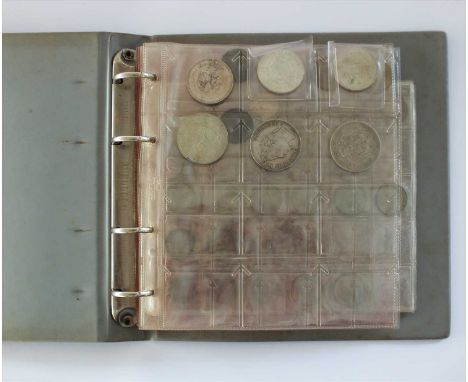An album of Foreign and Commonwealth silver, bronze and cupro-nickel coins, together with a few tokens
