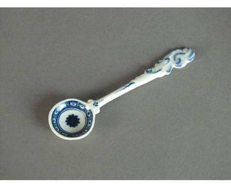 A Worcester mustard or condiment spoon circa 1770 the tapering flat handle moulded with an elaborate scroll finial picked out