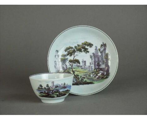A Worcester teabowl and saucer circa 1768 overglaze transfer-printed with additional hand-painted decoration, decorated with 