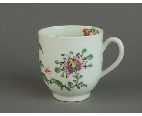A Worcester coffee cup circa 1762 of plain form with indented loop handle, painted in polychrome with honeysuckle and other f