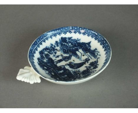 A Caughley egg drainer circa 1785 of circular form, the pierced bowl with a shell form handle, transfer-printed in underglaze