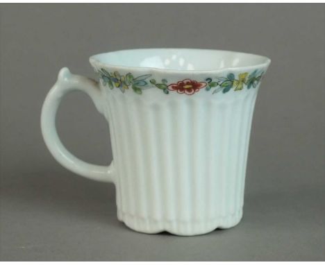 An early Worcester reeded coffee can circa 1752-54, with a scrolled handle, a floral border in enamels below the rim and an i