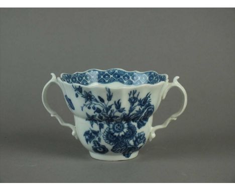 A Caughley chocolate cup circa 1785 of half fluted and waisted form, with overlapping double indented and moulded strap handl